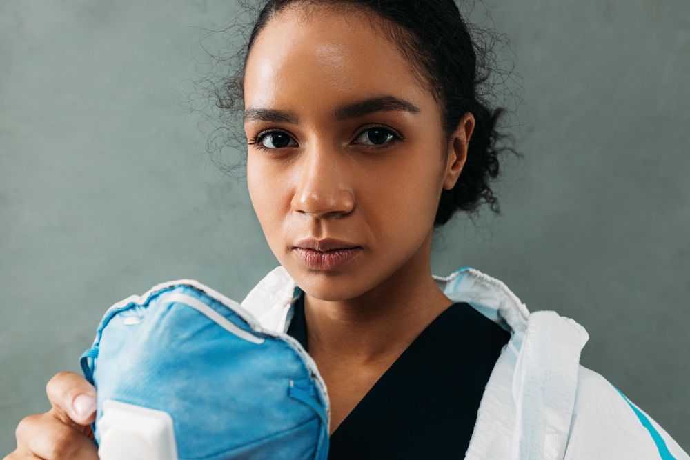 Black woman removing protective facemask