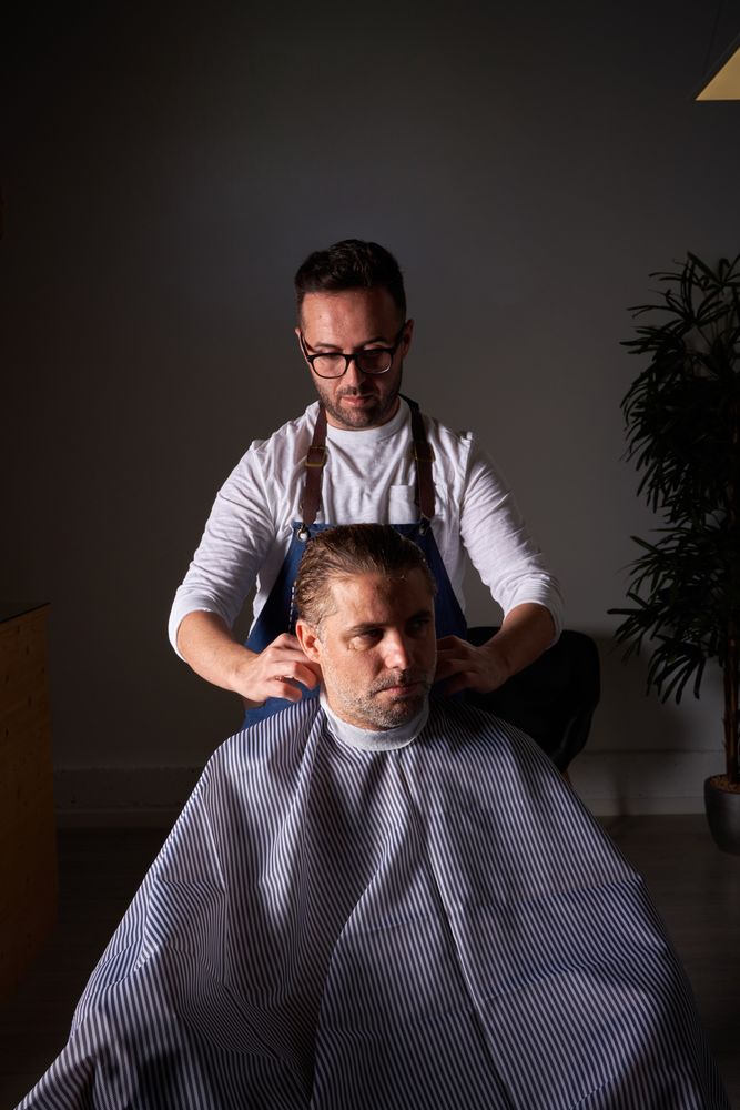 Barber making haircut to man