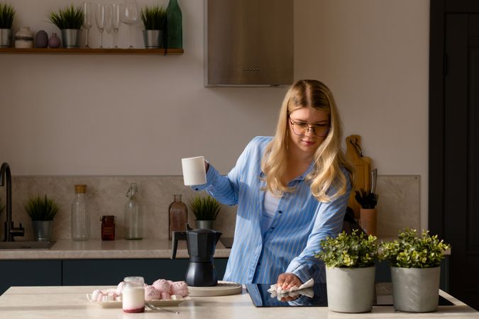 Woman with coffee in a modern kitchen