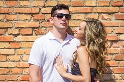 Couple portrait in front of brick wall
