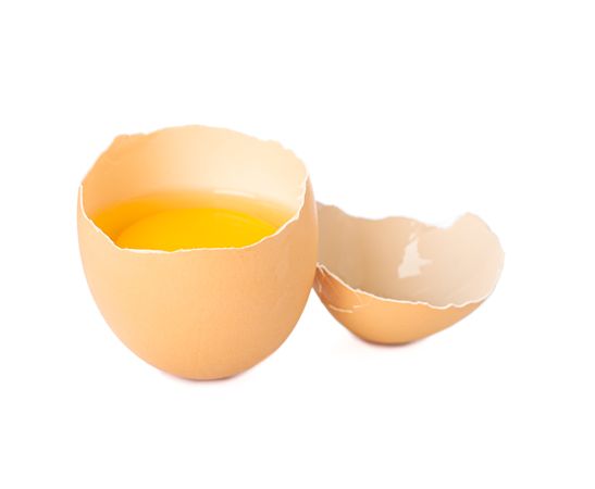 Half broken egg with yolk isolated on blank background