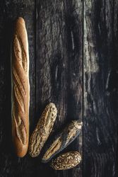 Assorted gold homemade bread on dark wood background