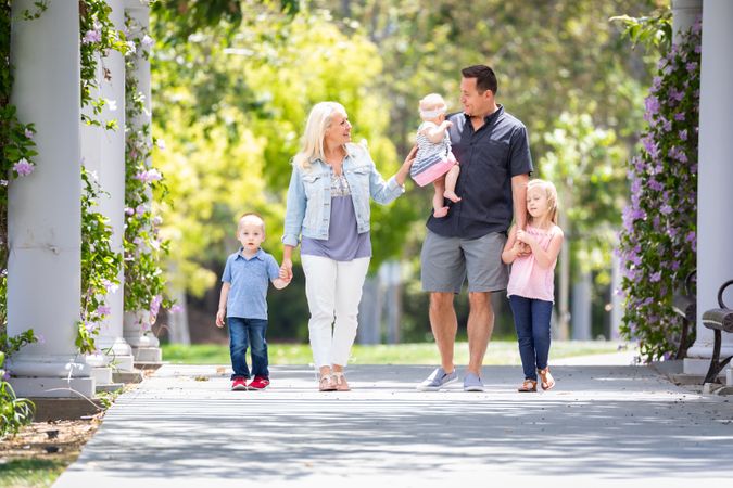 Young Family Taking A Walk In The Park
