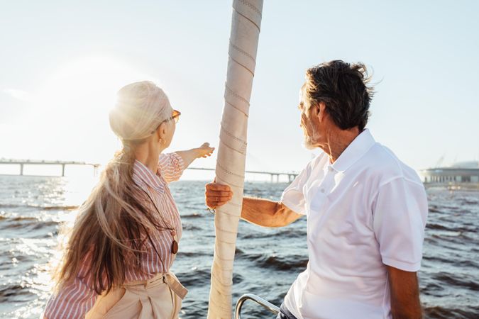 Rearview of two mature people sitting on a yacht bow