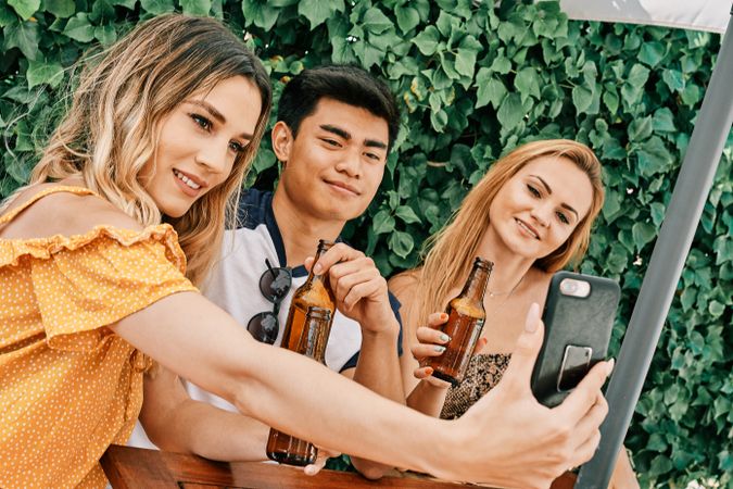 a group of young people making a selfie with last generation mobile phone