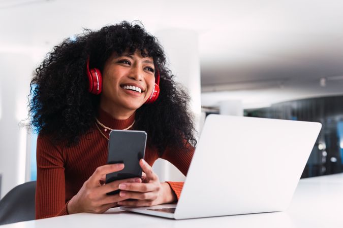 Black female with laptop and phone