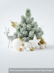 Snowy Christmas tree with  decorations on light background 0ywM74