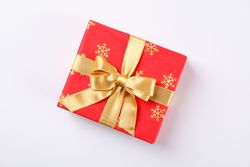 Beautiful gift box with golden bow on blank background, space for text