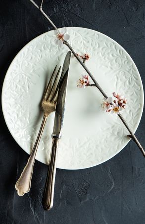 Delicate spring table setting with blooming tree branch