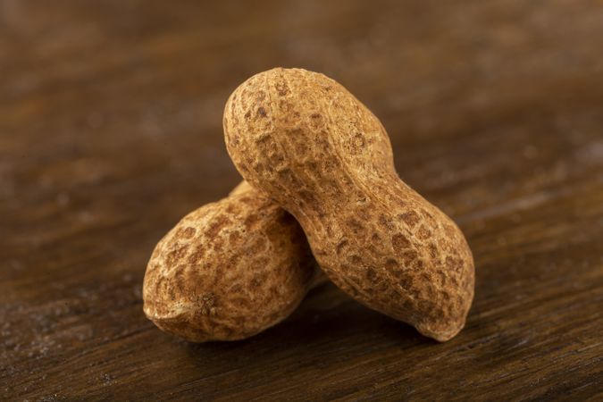 Dry peanut on the wooden background.