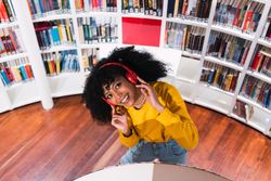Portrait of cheerful Black woman in headphones