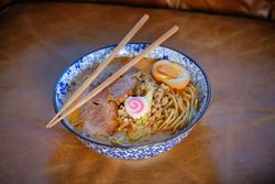 Asian noodle soup with chopsticks in bowl