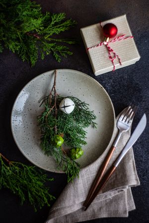 Top view of beige plate with gift and branch