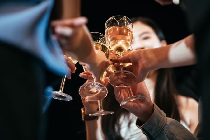 Group of  friend celebrating and toasting beverages at a party together