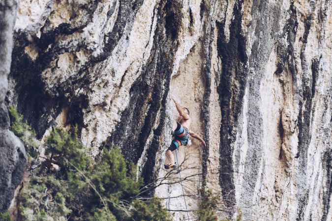 Anonymous man climbing rock