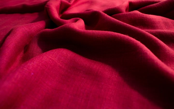 CLose up Red fabric wavy crumpled background texture.