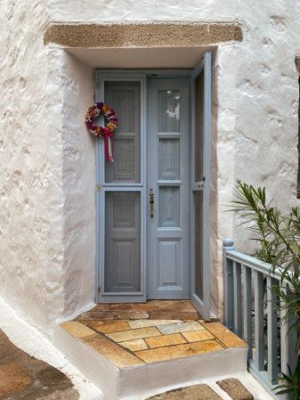 Patmian blue door with rail and wreath