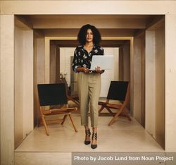 Businesswoman standing with open laptop 47yQk0