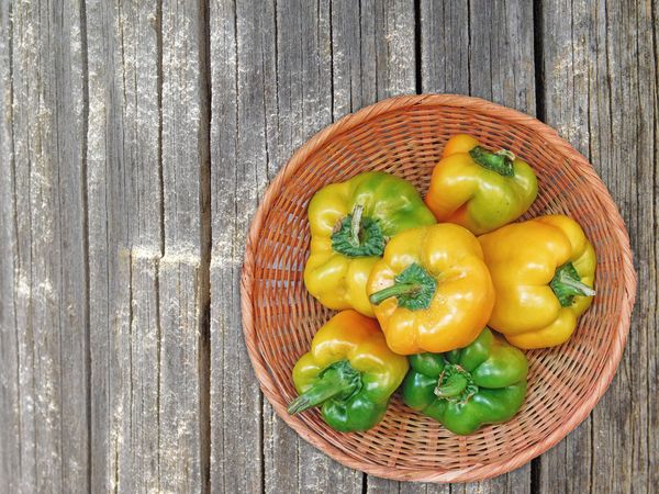 Peppers On The Wooden Background
