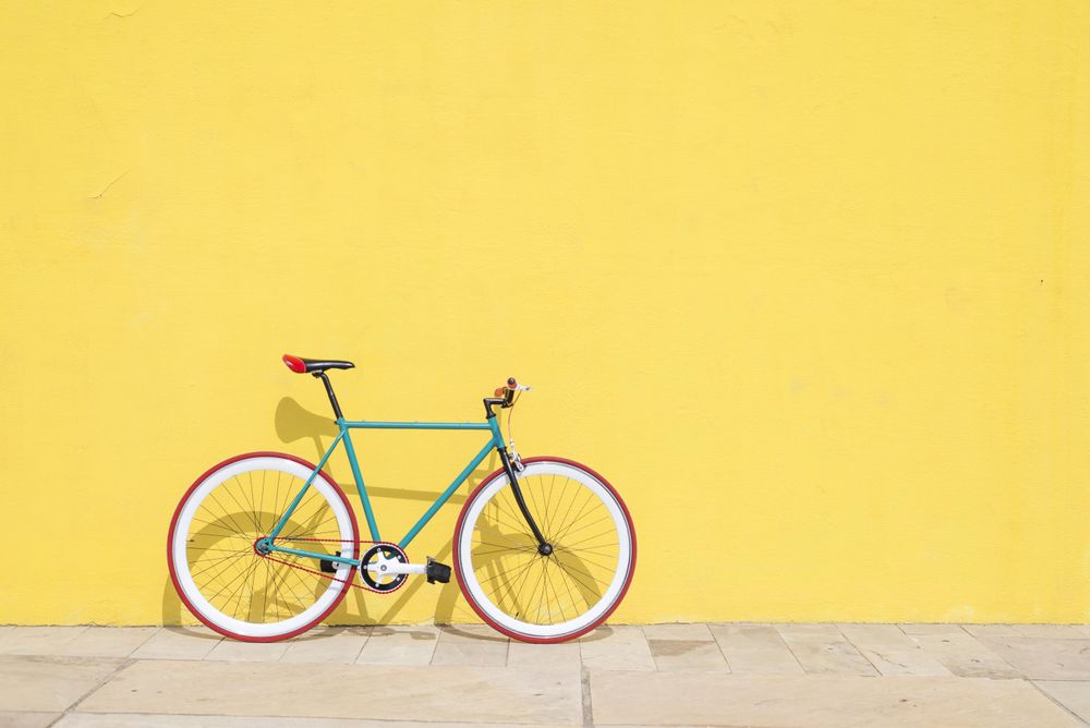 Full bike outside on bright yellow wall