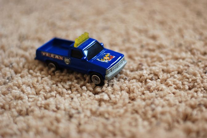 Small toy truck on beige carpet