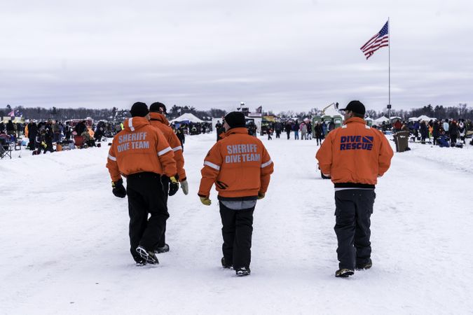 Nisswa, MN, USA - January 25th, 2020: Men in dive rescue gear patrolling an ice fishing competition