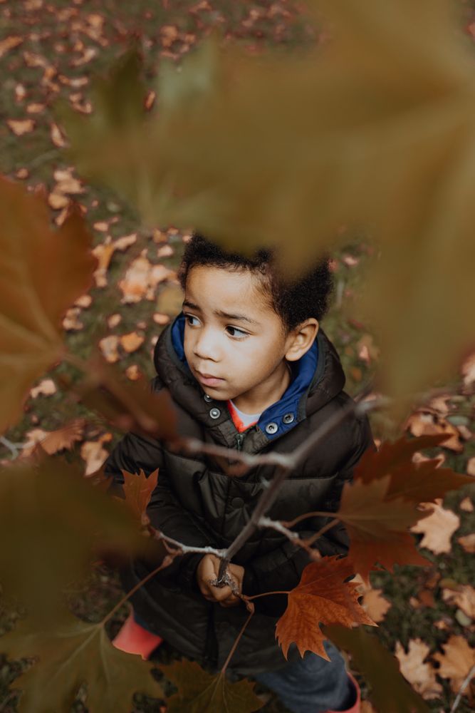 Black boy with autumn twig