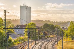 Railways near industrial tower and buildings
