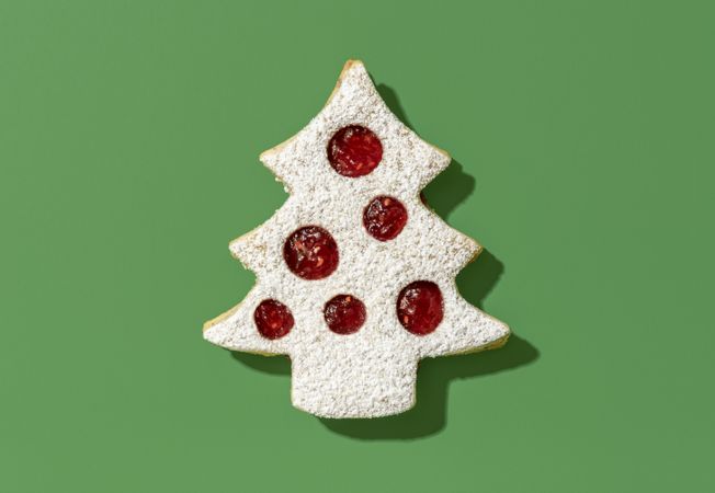 Christmas cookie with raspberry jam isolated on a green background