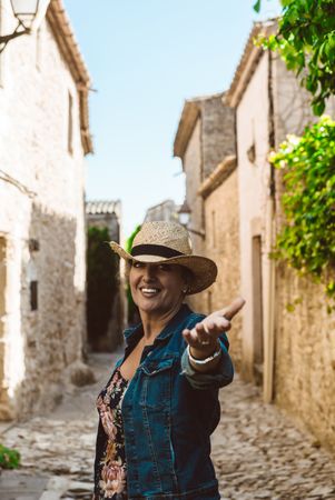 woman in dress and hat, visiting the village in Europe