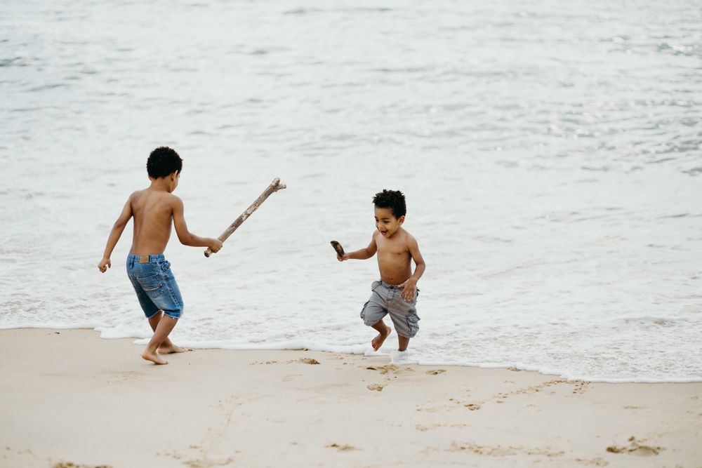 Black boys playing on beach