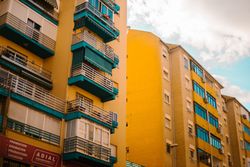 Cloudy sky over yellow apartment building
