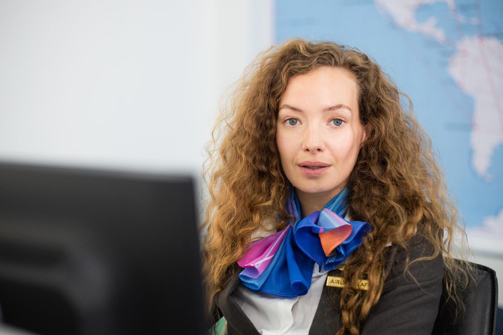 Female in flight attendant uniform working at counter