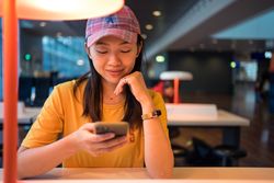 Asian woman browsing on smartphone