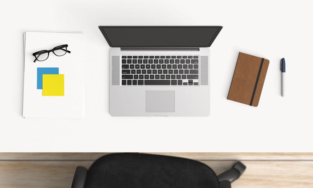 Modern workplace with coffee cup and smartphone or laptop copy space on office table background. Top view. Flat lay style