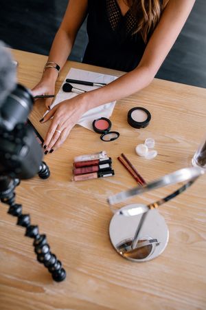 Woman making a video for her blog on newest cosmetics