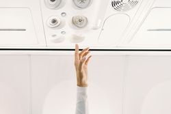 Person pressing button on panel up airplane