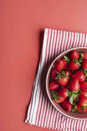 Organic bowl of strawberries on a kitchen towel
