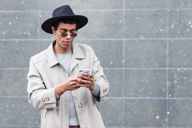 Stylish man with smartphone on street