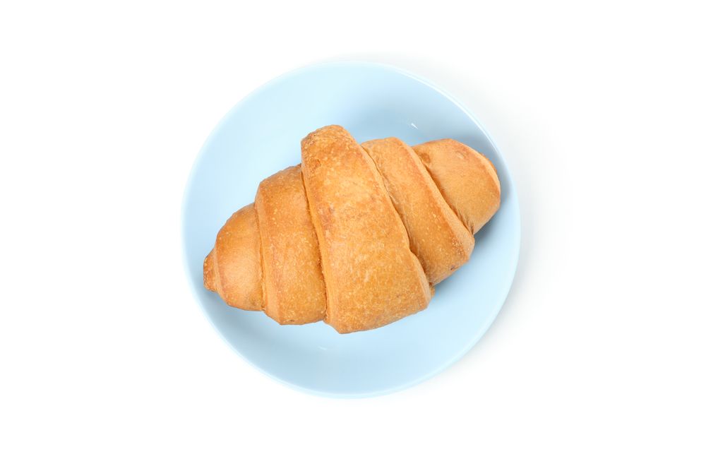 Top view of plate with croissant isolated on plain background