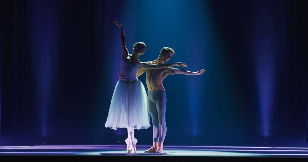 Cinematic Wide Shot of the Stage: Two Young Classical Ballet Dancers Performing in Theatre.