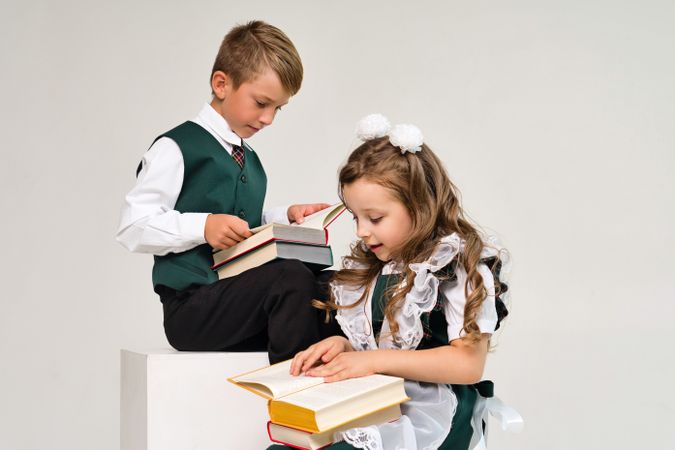 Uniform elementary school students read paper books with interest
