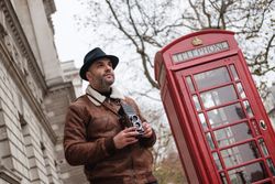 Male photographer near red telephone box