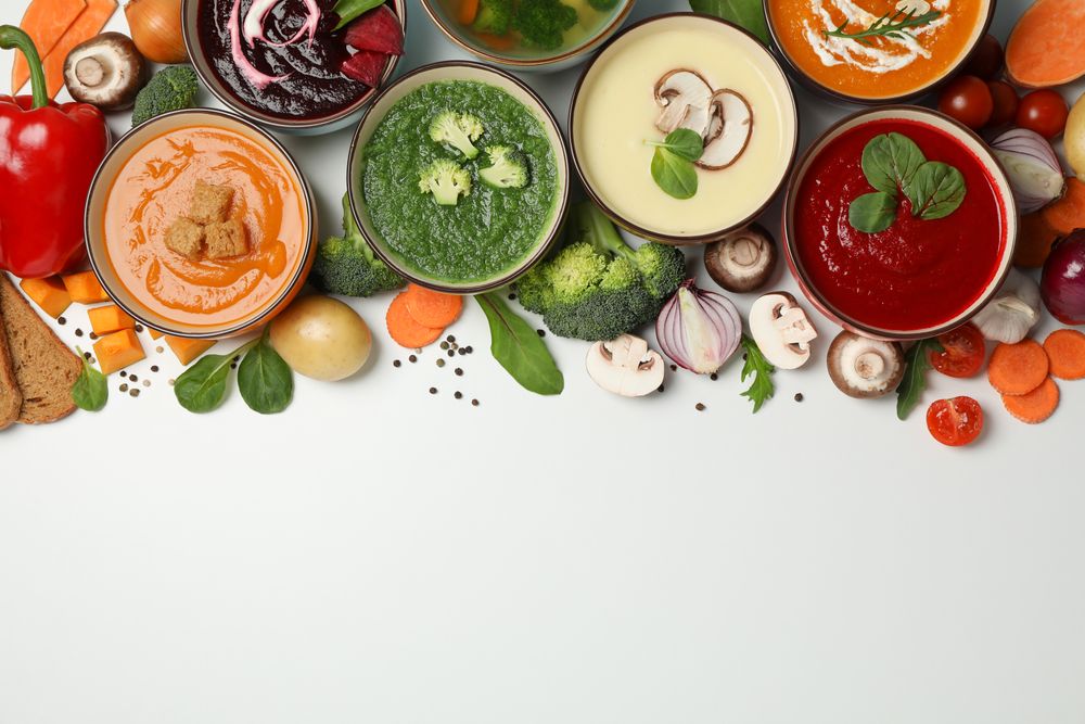 Colorful soups arranged on top of picture with copy space