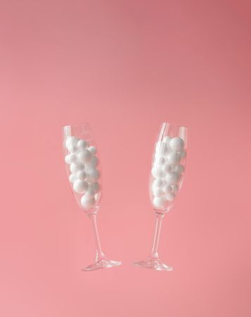 Pair of champagne glasses with light  bubbles with pastel background