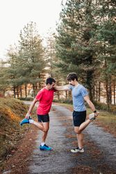 Sportsmen stretching after running in mountains