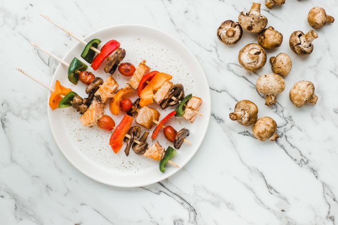 Served salmon cherry tomatoes mushrooms and peppers