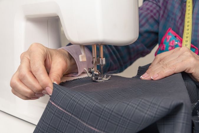 Seamstress hands working on a sewing machine
