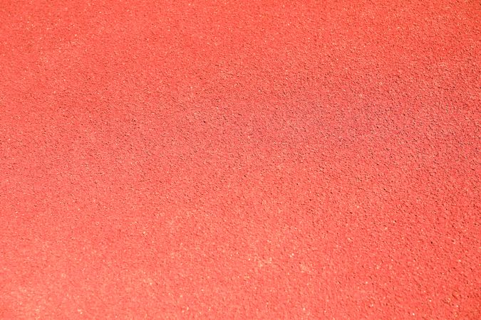 Red rubber running track background, top view