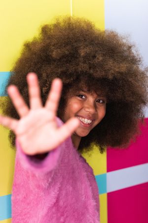 Content Black girl waving hand at camera